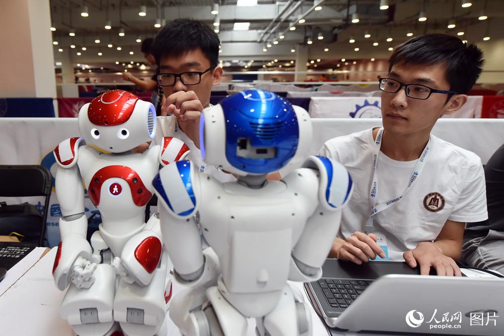 8月23日，参赛选手正在调试机器人，准备比赛。（人民网记者 翁奇羽摄）