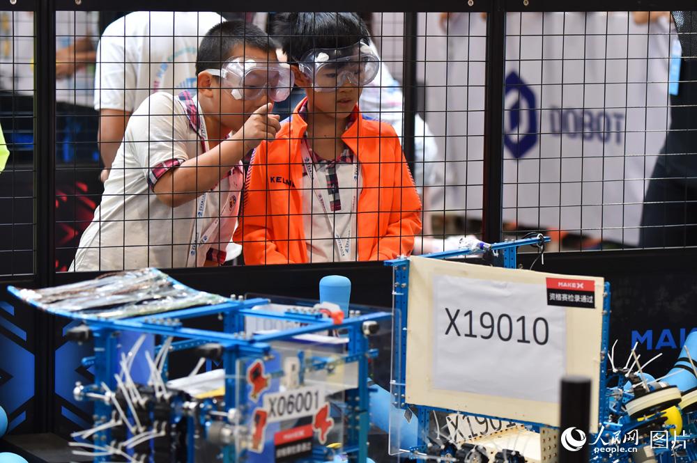 8月23日，参赛选手正在控制机器人进行“攻城大师”比赛。（人民网记者 翁奇羽摄）